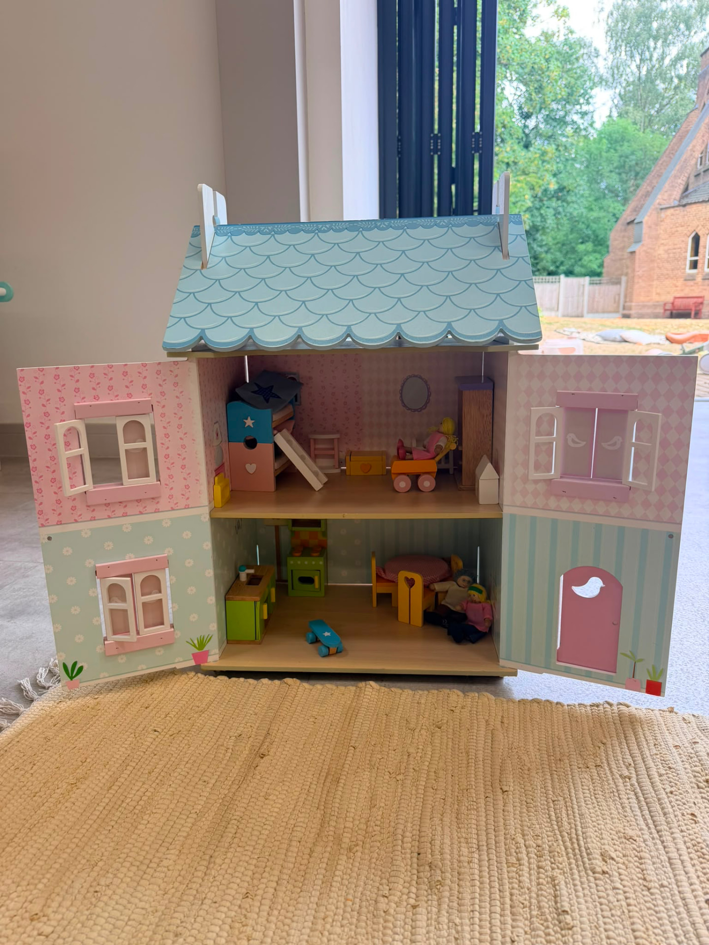 Wooden dolls house open and set up for play